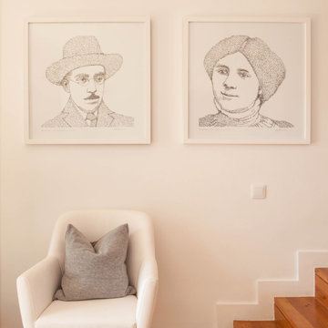 Birre Stair Hall with Armchair and Framed Portraits