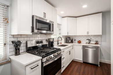 Inspiration for a mid-sized transitional galley enclosed kitchen remodel in Columbus with shaker cabinets, white cabinets, quartz countertops, white backsplash and white countertops