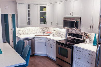 Mid-sized 1960s l-shaped medium tone wood floor and brown floor eat-in kitchen photo in Toronto with a drop-in sink, beaded inset cabinets, white cabinets, quartz countertops, gray backsplash, marble backsplash, stainless steel appliances, no island and white countertops