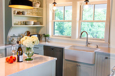 Inspiration for a small timeless u-shaped ceramic tile enclosed kitchen remodel in San Francisco with a farmhouse sink, flat-panel cabinets, gray cabinets, marble countertops, white backsplash, window backsplash, stainless steel appliances and an island