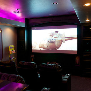 Inspiration for a medium sized contemporary enclosed home cinema in Oklahoma City with beige walls, carpet and a projector screen.