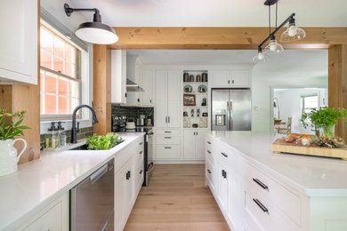 Small french country l-shaped eat-in kitchen photo in Other with a farmhouse sink, shaker cabinets, white cabinets, quartzite countertops, green backsplash, subway tile backsplash, stainless steel appliances, an island and white countertops