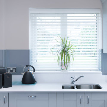 Airy open plan grey and white shaker style kitchen