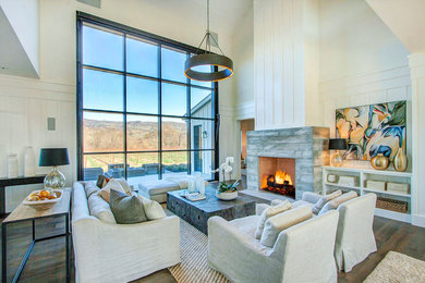 Inspiration for a country enclosed living room in San Francisco with white walls, dark hardwood floors, a standard fireplace and a concrete fireplace surround.