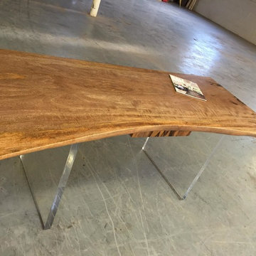 Lucite leg mango wood slab with raw edge and drawer desk.