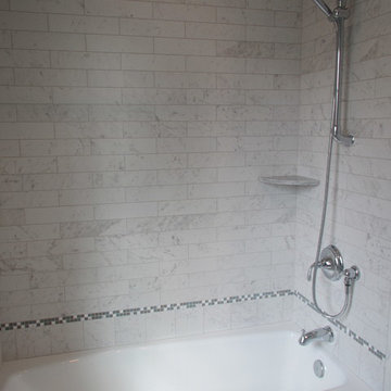 Bathroom Tub and Shower with Marble Tile Surround and Accent Border