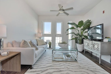 Small transitional loft-style dark wood floor living room photo in San Francisco with white walls, no fireplace and a tv stand