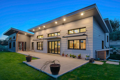 Mid-sized contemporary gray one-story mixed siding exterior home idea in Seattle