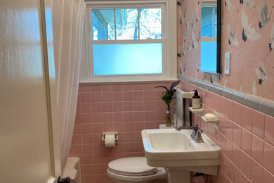 Small elegant pink tile and ceramic tile ceramic tile, pink floor and wallpaper alcove bathtub photo in Austin with pink walls