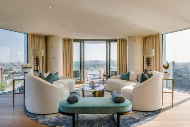Large contemporary open plan living room in London with light hardwood flooring and beige floors.