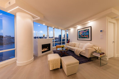 Living room - contemporary formal and open concept light wood floor living room idea in Vancouver with beige walls, a standard fireplace and no tv