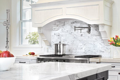 Mid-sized elegant l-shaped dark wood floor open concept kitchen photo in San Francisco with raised-panel cabinets, black cabinets, marble countertops, gray backsplash, stone tile backsplash, stainless steel appliances, an island and a farmhouse sink