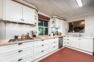 Large traditional l-shaped kitchen in Adelaide with a double-bowl sink, shaker cabinets, white cabinets, solid surface benchtops, stainless steel appliances and no island.