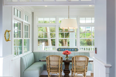 Example of a mid-sized beach style light wood floor and beige floor kitchen/dining room combo design in San Diego with gray walls and no fireplace
