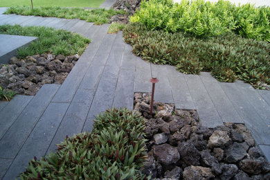 Design ideas for a large tropical rock and full sun side yard stone driveway in Hawaii for summer.