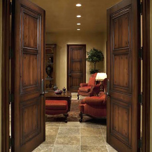 This is an example of a large mediterranean formal enclosed living room in Denver with beige walls and slate flooring.