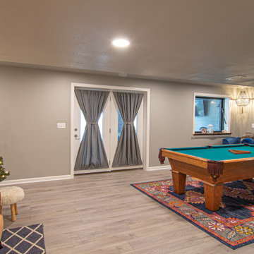 Basement Utilizing Open Space to Shoot Pool and Watch Favorite Sports Team