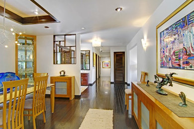 Entryway - large modern dark wood floor and brown floor entryway idea in San Francisco with white walls and a dark wood front door