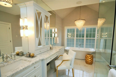 Example of a large transitional master white tile and porcelain tile porcelain tile and white floor bathroom design in Other with raised-panel cabinets, white cabinets, a one-piece toilet, beige walls, an undermount sink, marble countertops and a hinged shower door