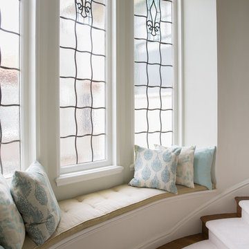 Elegant Curving Staircase with Walnut Floors and Window Seat