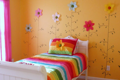 Photo of an eclectic kids' bedroom for kids 4-10 years old and girls in Philadelphia with yellow walls and carpet.