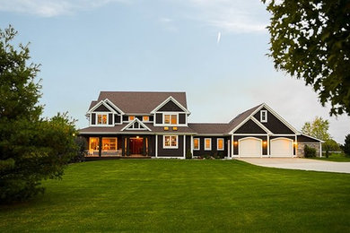Huge traditional brown two-story wood exterior home idea in Cleveland with a shingle roof