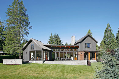 This is an example of a mid-sized transitional two-storey grey exterior in Seattle with wood siding and a gable roof.