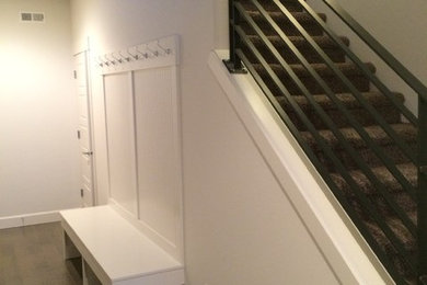 Example of a mid-sized transitional vinyl floor and gray floor mudroom design in Other with white walls and a white front door