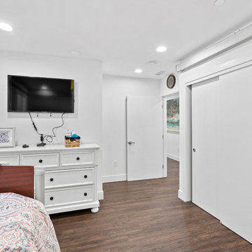 Accessible Bedroom with Wide Sliding Doors and Dark Wood-Look Flooring | Novato