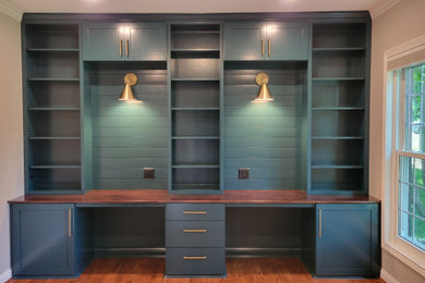 Inspiration for a large mid-century modern built-in desk dark wood floor and brown floor study room remodel in Cincinnati