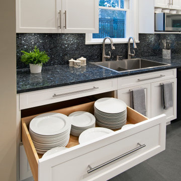 Functional & Stylish White Kitchen with Dark Countertops and Backsplash