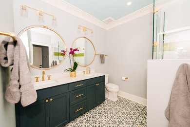Inspiration for a mid-sized transitional 3/4 cement tile floor and multicolored floor bathroom remodel in Charleston with recessed-panel cabinets, green cabinets, a two-piece toilet, gray walls, an undermount sink, marble countertops and white countertops
