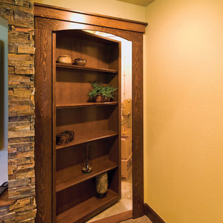 Photo of a large traditional walk-out basement in Denver with white walls, carpet, no fireplace and brown floors.