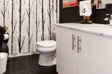 Minimalist 3/4 white tile and ceramic tile ceramic tile and black floor bathroom photo in Toronto with flat-panel cabinets, white cabinets, a two-piece toilet, black walls, an undermount sink, marble countertops and white countertops