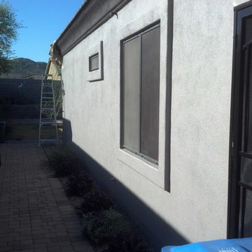 Barns exterior painting of south west stucco home. Pulling paper after painting