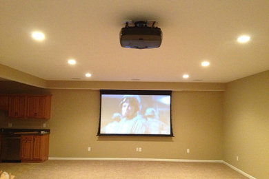 Traditional open concept home theatre in Other with carpet and a projector screen.