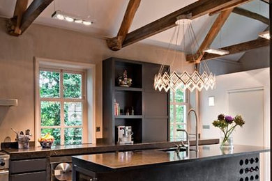 Enclosed kitchen - large transitional single-wall ceramic tile enclosed kitchen idea in Other with an undermount sink, flat-panel cabinets, black cabinets, stainless steel appliances and an island