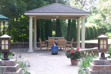 Inspiration for a backyard patio in Other with brick pavers and a gazebo/cabana.