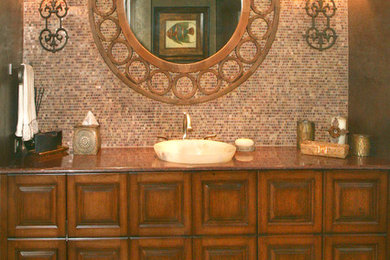 Example of a classic black tile bathroom design in Baltimore with furniture-like cabinets, medium tone wood cabinets, marble countertops and a vessel sink