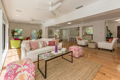 Living room - mid-sized eclectic open concept medium tone wood floor and brown floor living room idea in Tampa with white walls