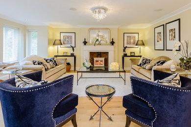 Mid-sized transitional enclosed light wood floor living room photo in Buckinghamshire with beige walls, a wood stove, a stone fireplace and no tv