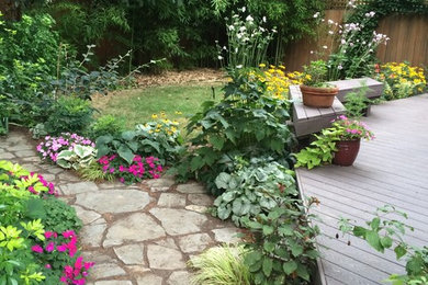 Small backyard partial sun garden in Portland with natural stone pavers.