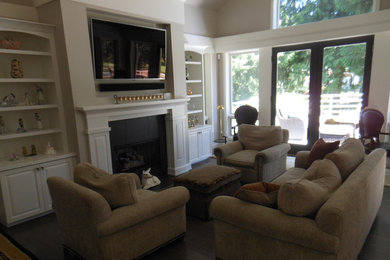 Living room - contemporary living room idea in Seattle with white walls, a standard fireplace, a wood fireplace surround and a wall-mounted tv
