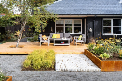 Design ideas for a medium sized scandinavian back partial sun garden for summer in Glasgow with a raised bed, decking and a wood fence.