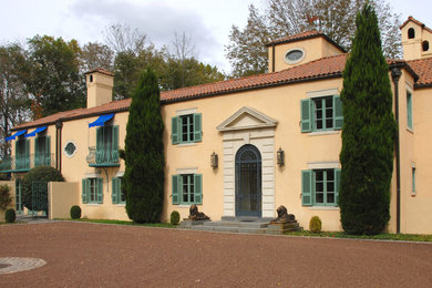 Mediterranean yellow two-story stucco house exterior idea in Philadelphia