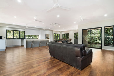 Design ideas for a large tropical living room in Darwin.