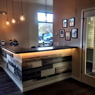 Photo of a large modern home office and library in Other with beige walls, dark hardwood flooring and a built-in desk.