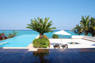 Inspiration for a backyard concrete paver infinity pool remodel in San Diego