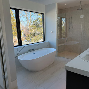 Primary Bathroom with Mitered Waterfall Tub Wall & Vanities
