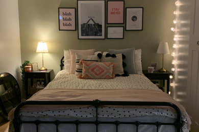 Inspiration for a small eclectic guest laminate floor and brown floor bedroom remodel in Other with green walls and no fireplace